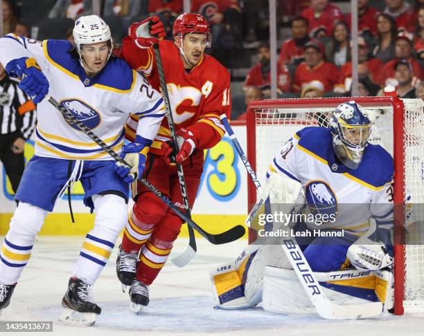 Buffalo Sabres Owen Power collides with Calgary Flames Mikael Backlund in front of Buffalo Sabres Eric Comrie at Scotiabank Saddledome on October 20,...