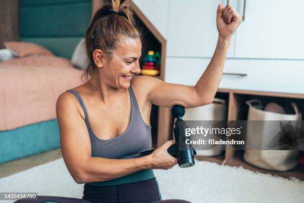 post-exercise massage therapy - massager stock pictures, royalty-free photos & images