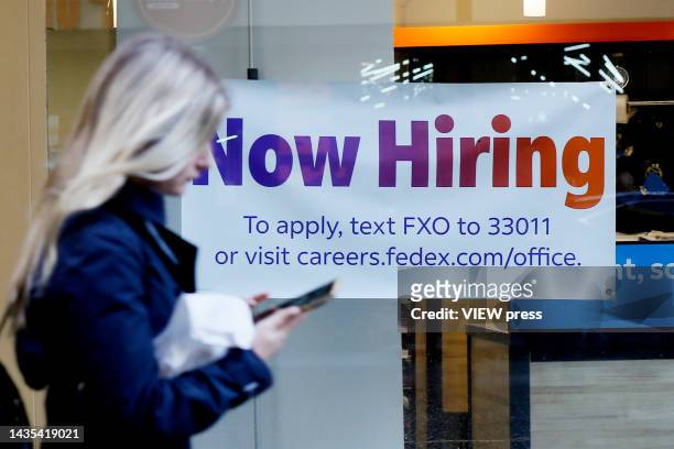 Now Hiring" sign is displayed on a shopfront on October 21, 2022 in New York City. New employment statistics show that in the past month, the jobless...