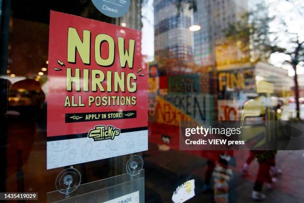 Now Hiring" sign is displayed on a shopfront on October 21, 2022 in New York City. New employment statistics show that in the past month, the jobless...