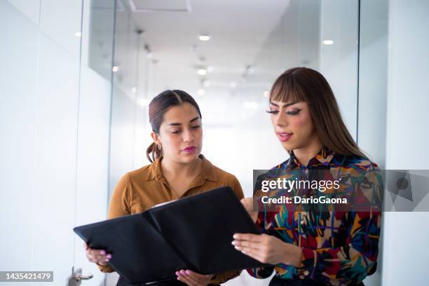 young woman and trans woman in the office - trana stock pictures, royalty-free photos & images