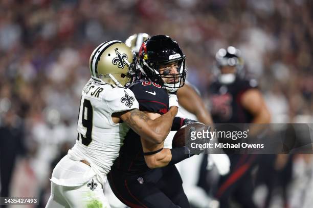 Zach Ertz of the Arizona Cardinals is tackled by Chris Harris Jr. #19 of the New Orleans Saints during an NFL football game between the Arizona...