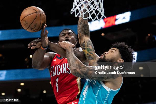 Nick Richards of the Charlotte Hornets fouls Zion Williamson of the New Orleans Pelicans in the first quarter during their game at Spectrum Center on...
