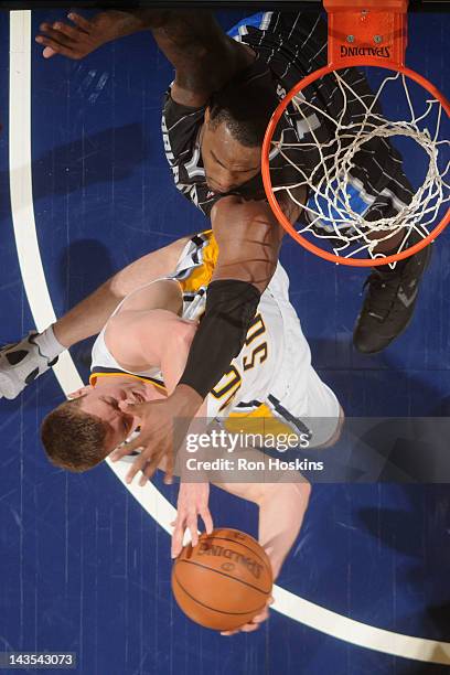 Tyler Hansbrough of the Indiana Pacers drives to the basket against Glen Davis of the Orlando Magic in Game One of the Eastern Conference...