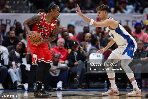 DeMar DeRozan of the Chicago Bulls handles the ball as Deni Avdija of the Washington Wizards defends during the first half at Capital One Arena on...
