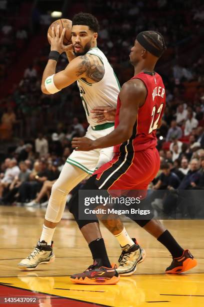 Jimmy Butler of the Miami Heat guards Jayson Tatum of the Boston Celtics during the first quarter at FTX Arena on October 21, 2022 in Miami, Florida....