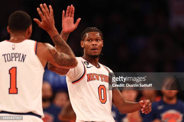 Cam Reddish of the New York Knicks high fives Obi Toppin of the New York Knicks during the second quarter of the game against the Detroit Pistons at...
