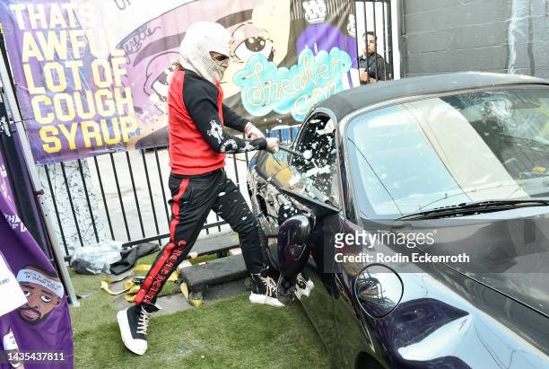 Lil Pump smashes a Porche at the Mosh Pit Pop Up he hosted on October 21, 2022 in Los Angeles, California.