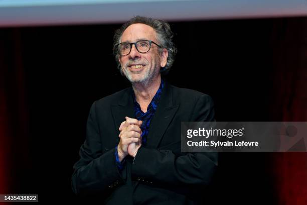 Tim Burton acknowledges the audience onstage the Lumiere Award ceremony during the 14th Film Festival Lumiere on October 21, 2022 in Lyon, France.