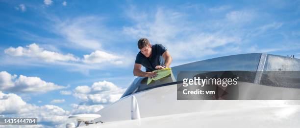 man cleaning and polishing front shield on yacht - cleaning crew stock pictures, royalty-free photos & images
