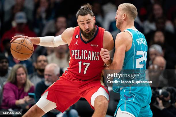 Mason Plumlee of the Charlotte Hornets guards Jonas Valanciunas of the New Orleans Pelicans in the third quarter during their game at Spectrum Center...