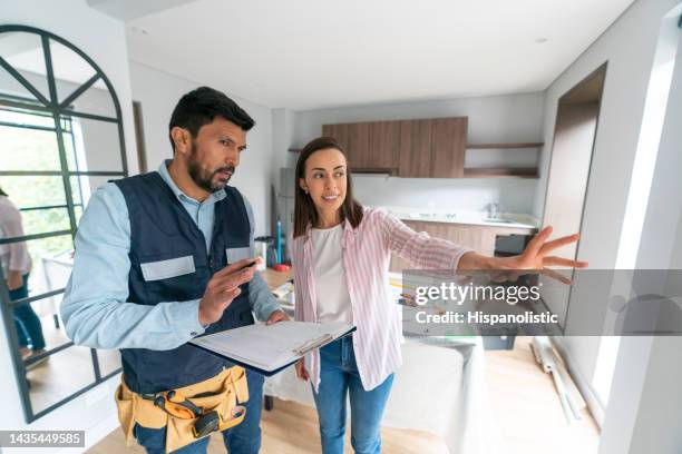 woman remodeling her house and explaining her needs to the contractor - customer needs stock pictures, royalty-free photos & images