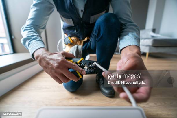 internet technician installing a router at a house - installation stockfoto's en -beelden