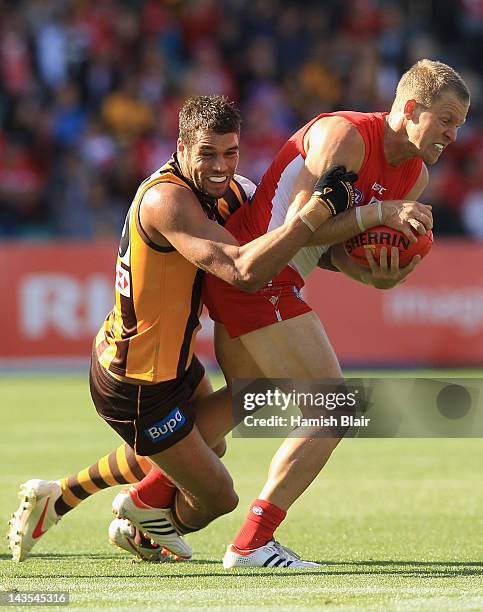 Ryan O'Keefe of the Swans is tackled by Lance Franklin of the Hawks during the round five AFL match between the Hawthorn Hawks and the Sydney Swans...