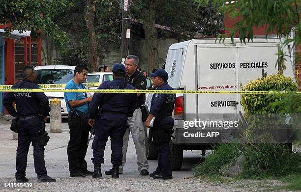 Members of the Police and Service Forense of the Veracruz gather outside the house of Mexican journalist Regina Martinez, in Xalapa, Veracruz State,...