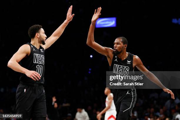 Ben Simmons celebrates with Kevin Durant of the Brooklyn Nets during the second half against the Toronto Raptors at Barclays Center on October 21,...