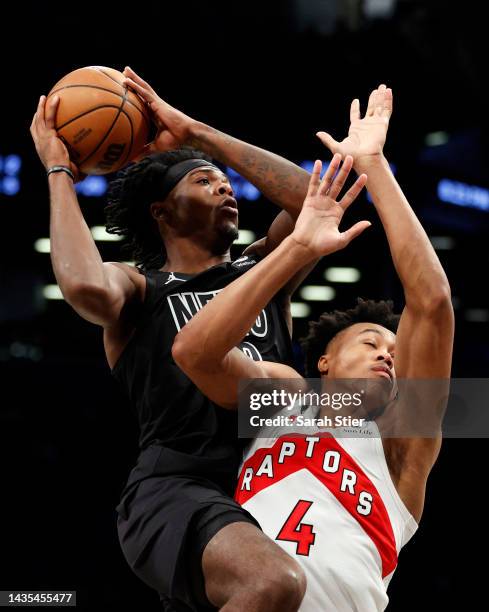 Day'Ron Sharpe of the Brooklyn Nets goes to the basket as Scottie Barnes of the Toronto Raptors defends during the first half at Barclays Center on...