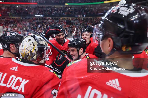 Max Domi of the Chicago Blackhawks celebrates with teammates after scoring a game-winning goal in overtime against the Detroit Red Wings at United...