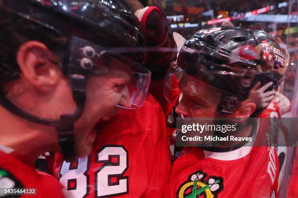 Max Domi of the Chicago Blackhawks celebrates with teammates after scoring a game-winning goal in overtime against the Detroit Red Wings at United...