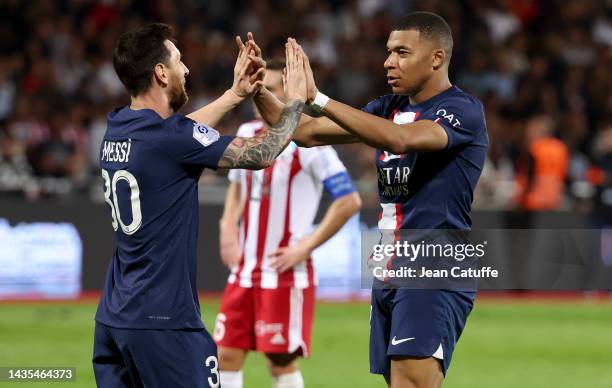 Kylian Mbappe of PSG celebrates his second goal with Lionel Messi during the Ligue 1 match between AC Ajaccio and Paris Saint-Germain at Stade...