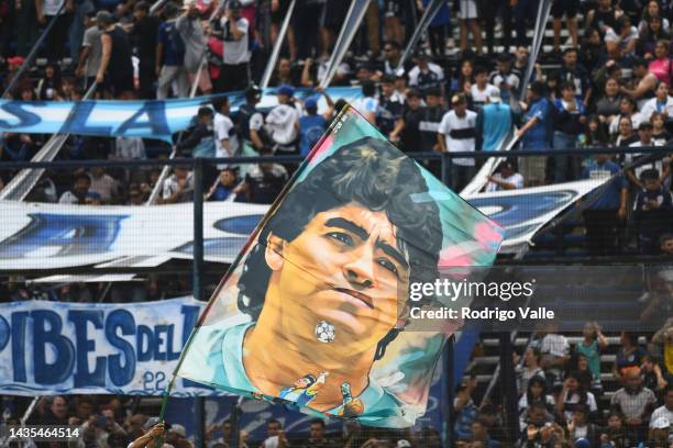 Fans of Gimnasia wave a flag of Diego Maradona before a match between Gimnasia y Esgrima La Plata and Boca Juniors as part of Liga Profesional 2022...