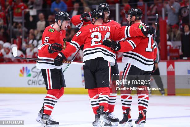 Connor Murphy of the Chicago Blackhawks celebrates with teammates after scoring a goal against the Detroit Red Wings during the third period at...