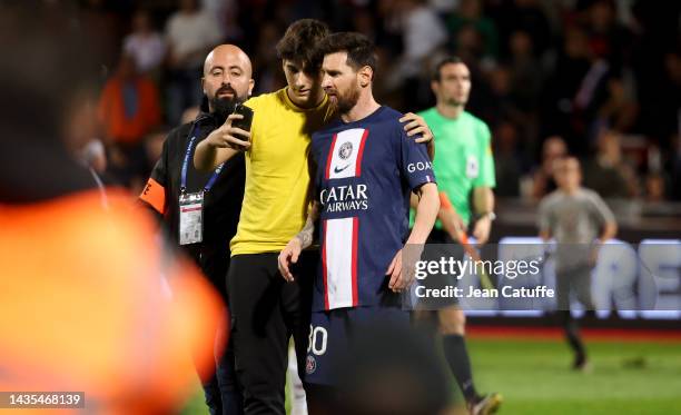 Lionel Messi of PSG with a young pitch invader asking for a selfie following the Ligue 1 match between AC Ajaccio and Paris Saint-Germain at Stade...