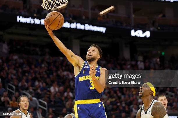 Stephen Curry of the Golden State Warriors goes up for a shot on Kentavious Caldwell-Pope of the Denver Nuggets at Chase Center on October 21, 2022...