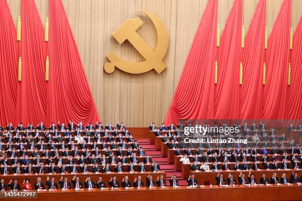 Delegates vote at the closing ceremony of the 20th National Congress of the Communist Party of China at the Great Hall of the People on October 22,...