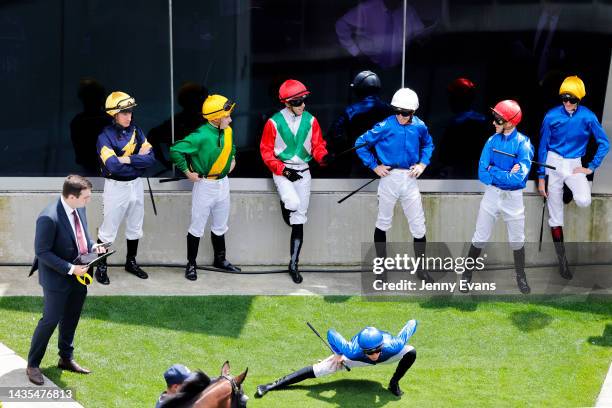Jockeys stretch and wait to mount up ahead of race 2 during Spring Champions Stakes Day at Royal Randwick Racecourse on October 22, 2022 in Sydney,...