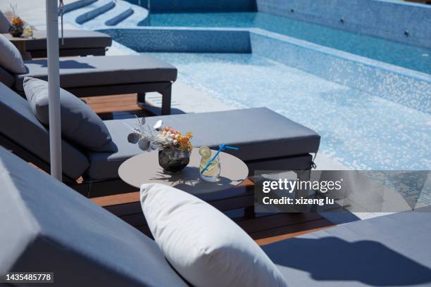 sun loungers by the pool - pool table stock-fotos und bilder