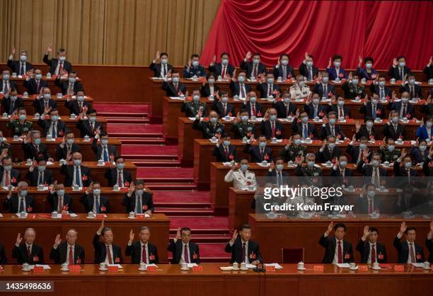 Chinese President Xi Jinping, centre, bottom, and other senior members of the government raise their hands to vote during the closing session of the...