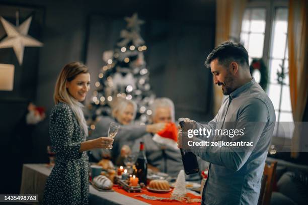 multigeneration family toasting during new years dinner at home - serbia tradition stock pictures, royalty-free photos & images