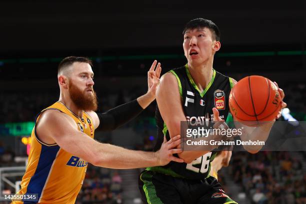 Zhou Qi of the Phoenix and Aron Baynes of the Bullets compete during the round four NBL match between South East Melbourne Phoenix and Brisbane...