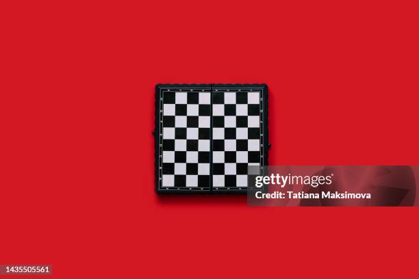 single object chess board on red background, top view. - chess board overhead stock pictures, royalty-free photos & images