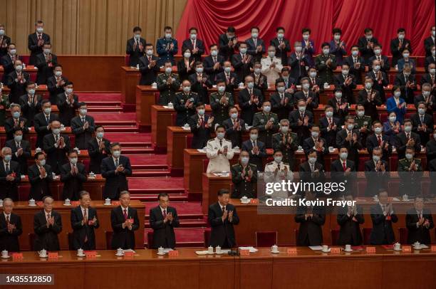 Chinese President Xi Jinping, centre, bottom, and other senior members of the government applaud during the closing session of the 20th National...