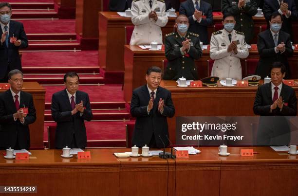 Chinese President Xi Jinping, right, and Premier Li Keqiang applaud during the closing session of the 20th National Congress of the Communist Party...