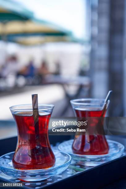 turkish tea in traditional glass. traditional tea plate. - harvest caye stock pictures, royalty-free photos & images