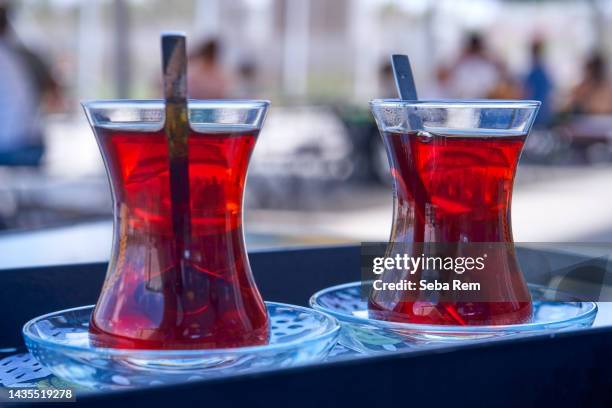 turkish tea in traditional glass. traditional tea plate. - harvest caye stock pictures, royalty-free photos & images