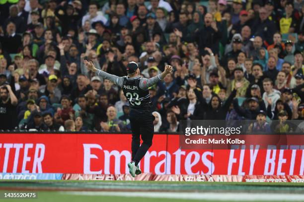 Glenn Phillips of New Zealand celebrates catching Marcus Stoinis of Australia off a delivery by team mate Mitchell Santner of New Zealand during the...