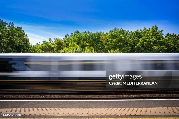 bewegungsverschwommener zug in london in großbritannien an einem sonnigen sommertag england - railways uk stock-fotos und bilder