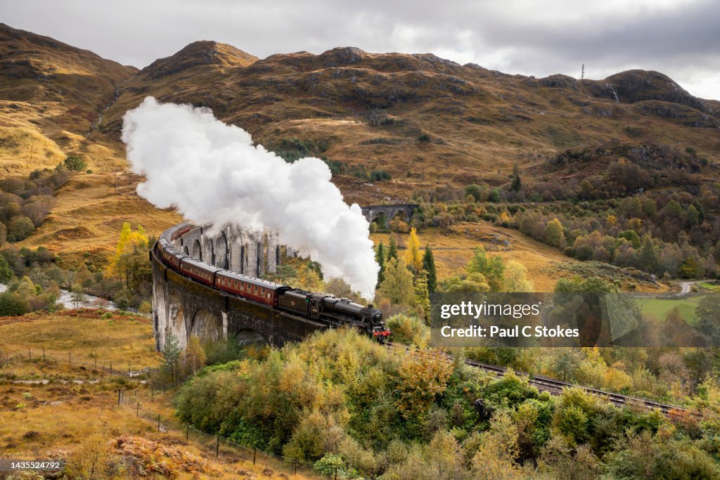 The Jacobite Steam train Crossing the Glenfinnan Viaduct in Scotland.