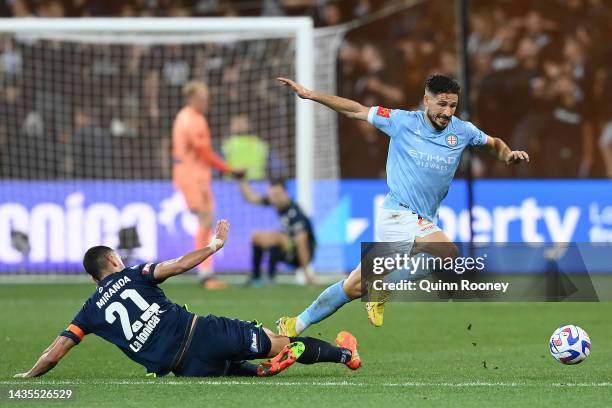 Mathew Leckie of Melbourne City is tackled by Roderick Miranda of the Victory during the round three A-League Men's match between Melbourne Victory...