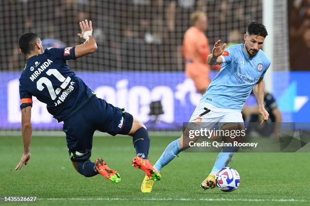 Mathew Leckie of Melbourne City is tackled by Roderick Miranda of the Victory during the round three A-League Men's match between Melbourne Victory...