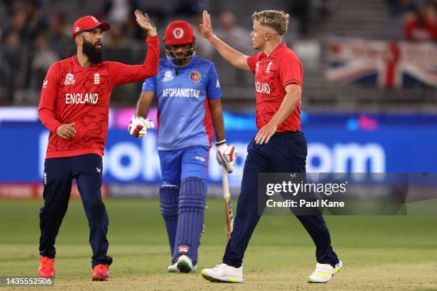 Moeen Ali and Sam Curran of England celebrates the wicket of Rashid Khan of Afghanistan during the ICC Men's T20 World Cup match between England and...