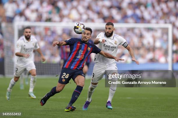 Eric Garcia of FC Barcelona competes for the ball with Karim Benzema of Real Madrid CF during the LaLiga Santander match between Real Madrid CF and...