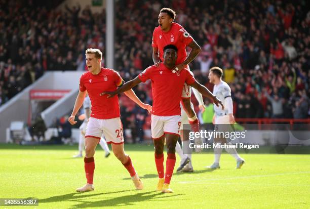 Taiwo Awoniyi of Nottingham Forest celebrates with teammates Ryan Yates and Jesse Lingard after scoring their team's first goal during the Premier...