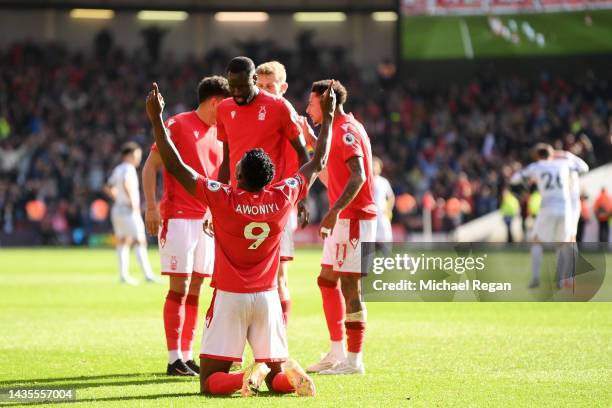 Taiwo Awoniyi of Nottingham Forest celebrates with teammates after scoring their team's first goal during the Premier League match between Nottingham...