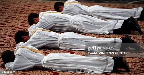 Priests prostate themselves during a mass celebrated by Pope Benedict XVI during a priests ordination ceremony on April 29, 2012 in St Peter's...