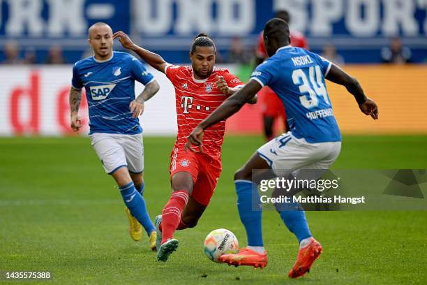 Serge Gnabry of Bayern Munich is challenged by Stanley Nsoki of TSG 1899 Hoffenheim during the Bundesliga match between TSG Hoffenheim and FC Bayern...